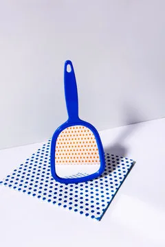 Hand mirror on spotted patterned wipe, showing different reflection of images.  Abstract conception. Mirror collection.