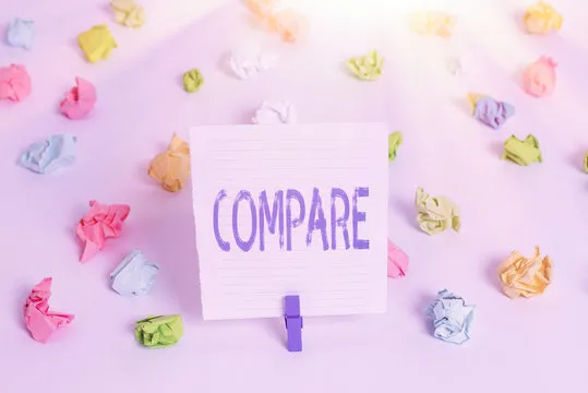 Word writing text Compare. Business photo showcasing Estimate Measure Note the similarities dissimilarities between Colored crumpled papers empty reminder white floor background clothespin