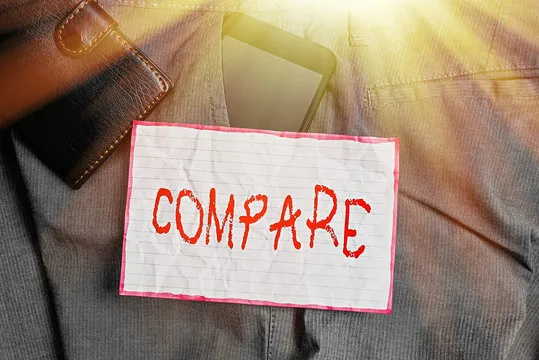 Text sign showing Compare. Business photo showcasing Estimate Measure Note the similarities dissimilarities between Smartphone device inside trousers front pocket with wallet and note paper