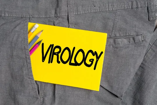 Writing note showing Virology. Business concept for branch of science dealing with the variety of viral agents and disease Writing equipment and yellow note paper inside pocket of man trousers