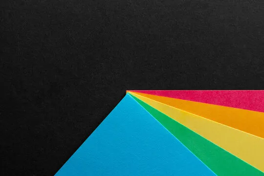 Colored rainbow paper corners on black textured background. Business concept. Layout for design. Copy space. High quality photo